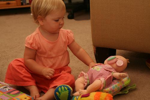 Then she opened her new baby doll from Yaya and Papa - here she is already taking such good care of her.
