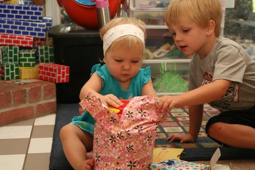 Wesley helping Jillian open her new playdough toys.