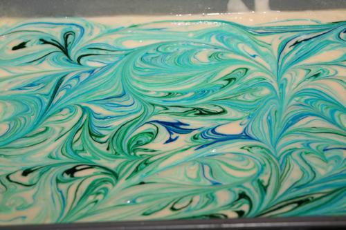 Adding blue and green to the cake to make it look like water.